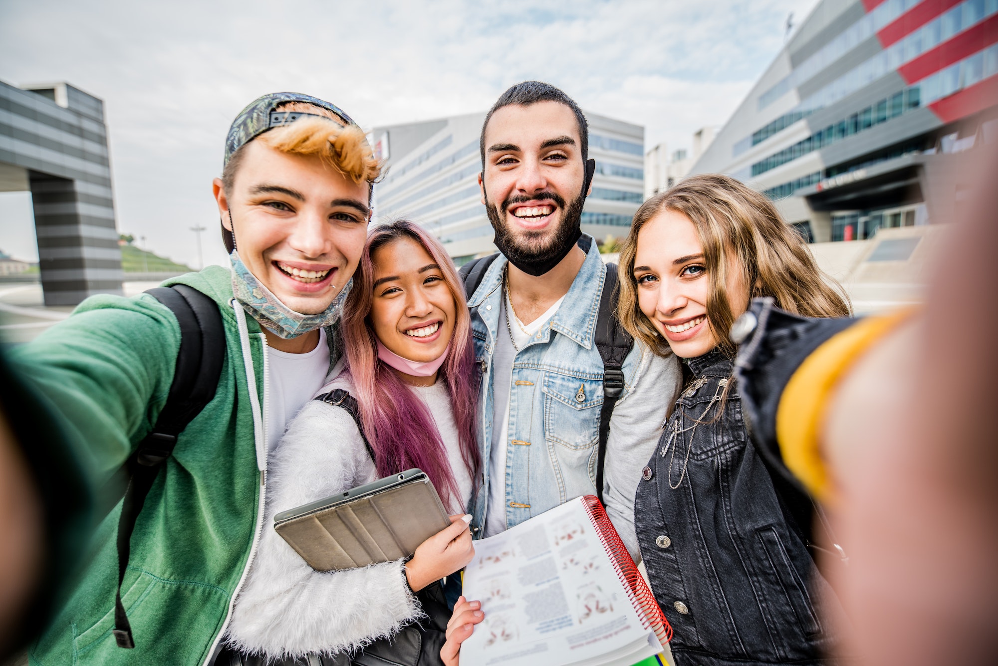 AGroup of happy students taking a selfie at school